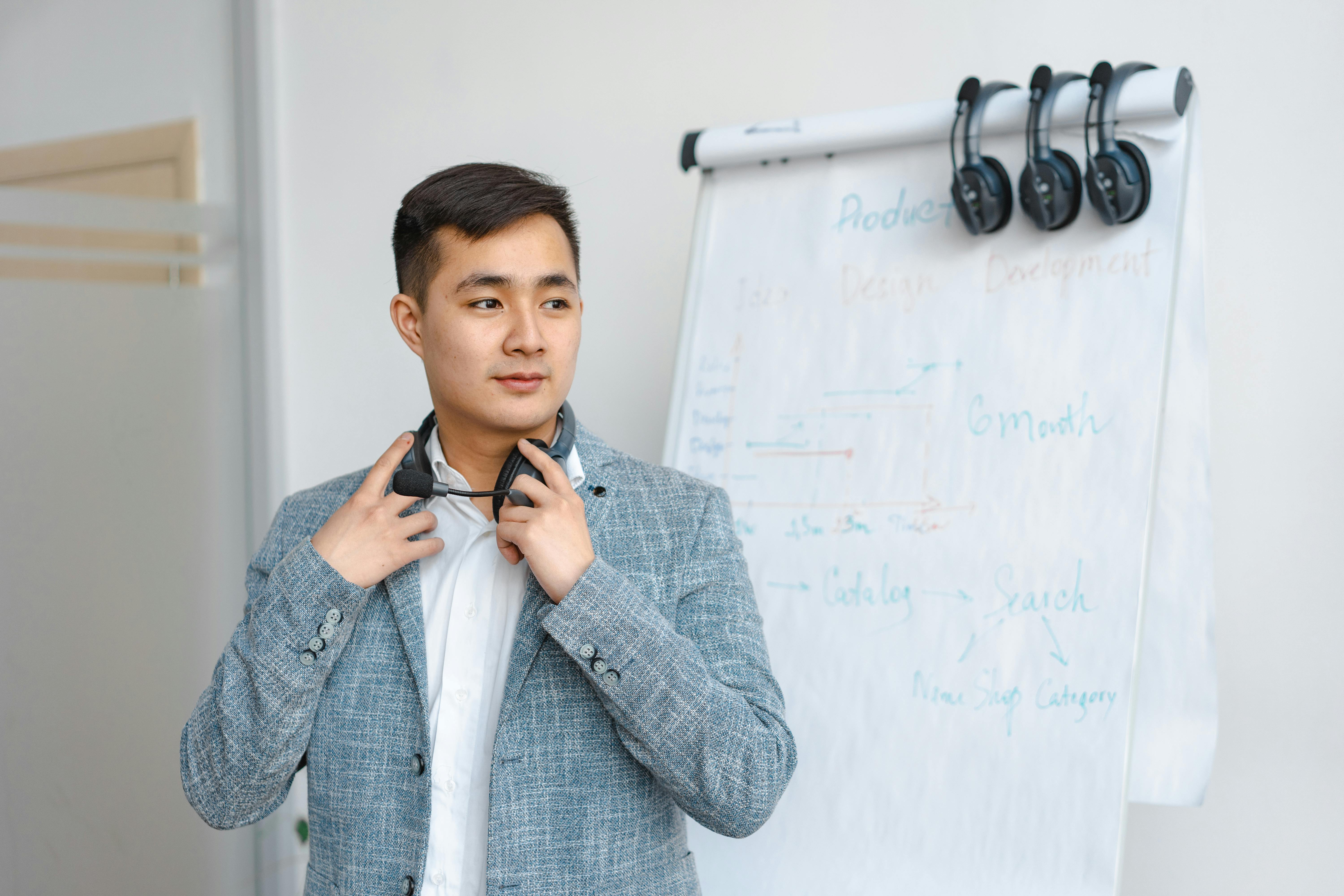 Confident office worker standing by whiteboard with development timeline. Ideal for business themes.
